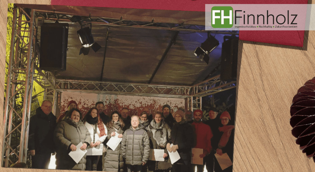 Strahlende Gesichter auf dem Weihnachtsmarkt in Lienen 2025: Auf dem Bild sind die Spendenempfänger der diesjährigen Weihnachtsspende der Industrie Akzeptanzoffensive (zu der auch FH Finnholz gehört) zu sehen. 