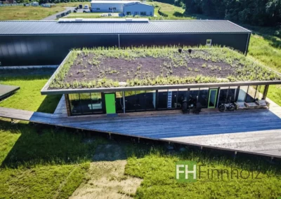 Großer Büropavillon mit Gründach in Havixbeck und umlaufender Holzterrasse.